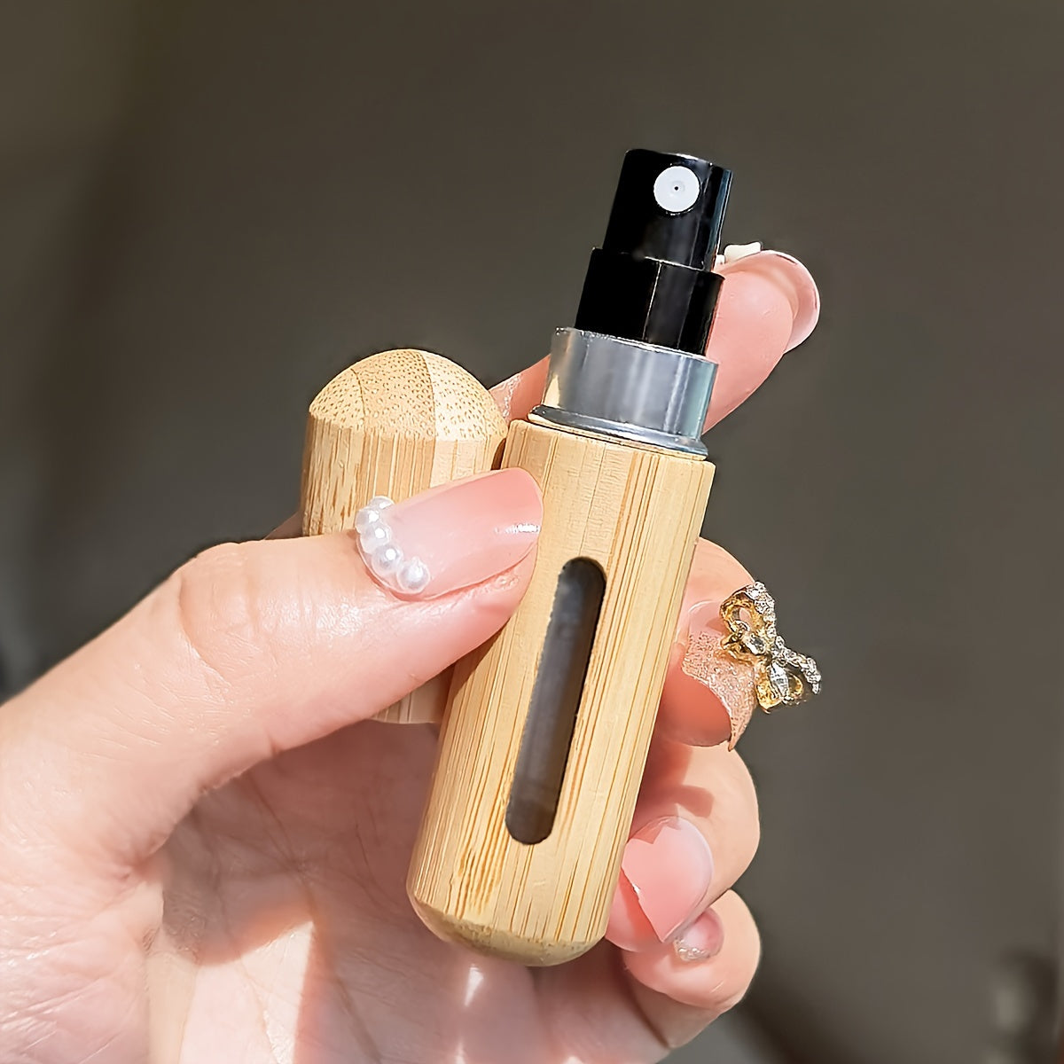 Set of bamboo shell perfume atomizers, refillable spray bottles in 5ml & 8ml sizes. Portable and luxurious fragrance dispensers with visible window, ideal for travel and outdoors.