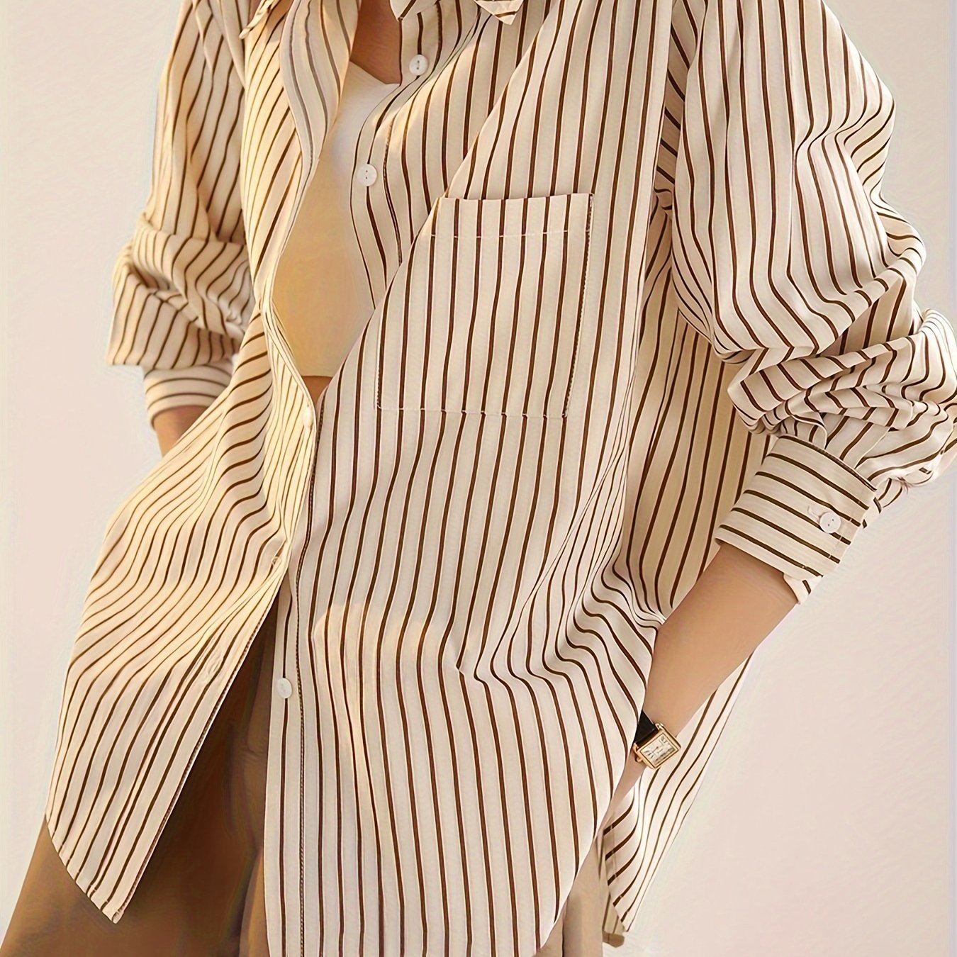 Elegant striped button-up shirt for women with a French-inspired design in beige and brown vertical stripes for spring/summer.