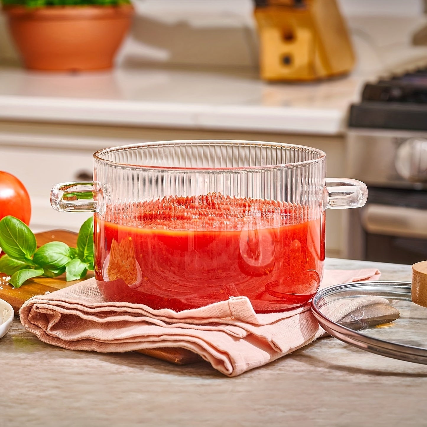 Glass cooking pot with lid, 1.6L (54oz) capacity made of heat resistant borosilicate glass. This stovetop pot set includes a paella pan and simmer pot with a cover, safe for soup.