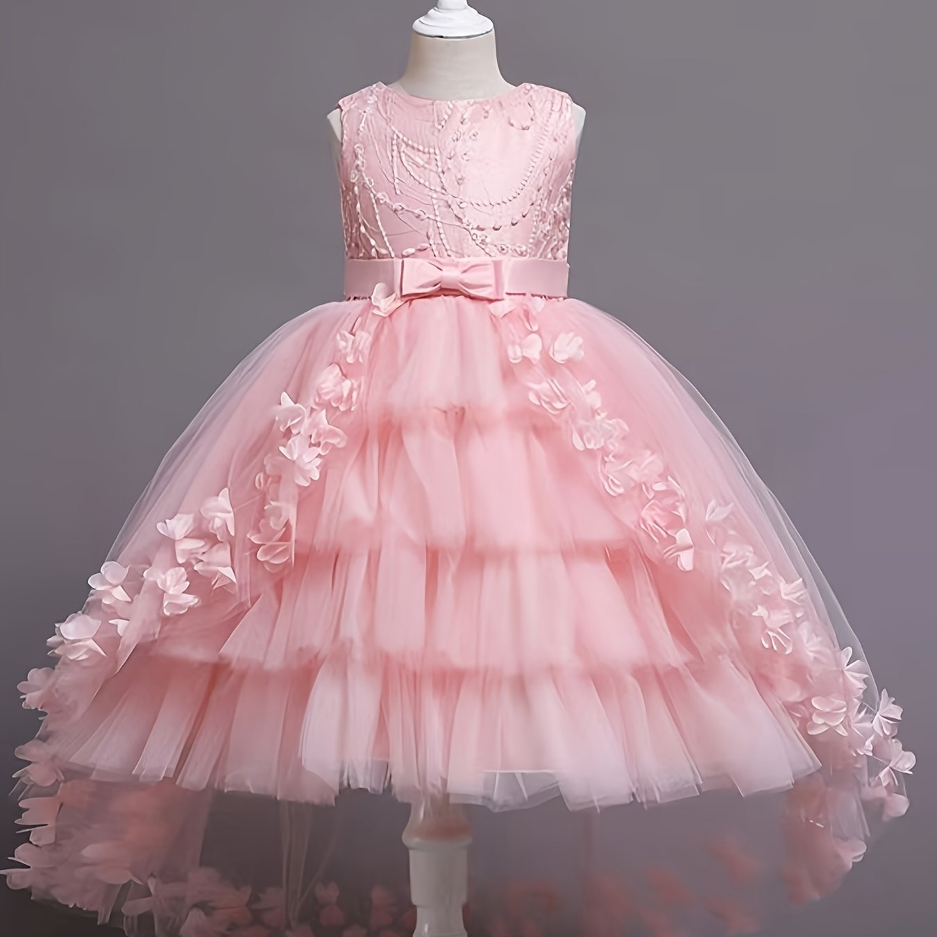 Stylish pink princess dress for girls with floral appliqués, tulle overlay, and bow detail - perfect for pageants, parties, and performances.