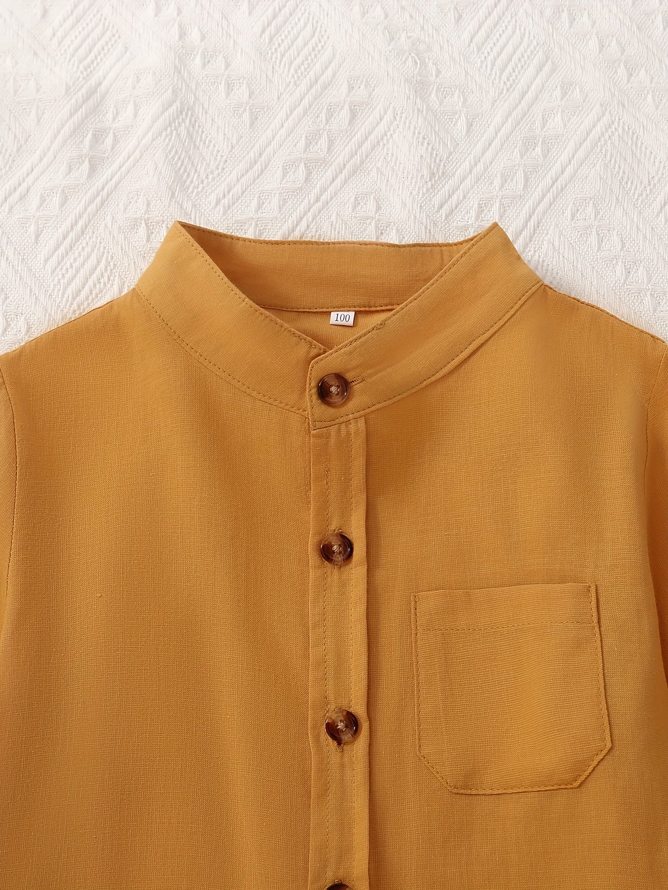 2 boys solid color stand collar shirts with long sleeves and button-up design, suitable for spring and fall wear.