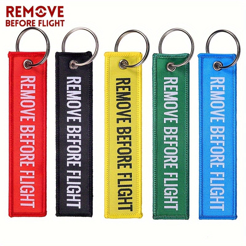 Bundle of 50 'Remove Before Flight' Woven Keychains made from sturdy polyester material - Ideal present for pilots and aviation fans, featuring the iconic phrase "REMOVE BEFORE FLIGHT