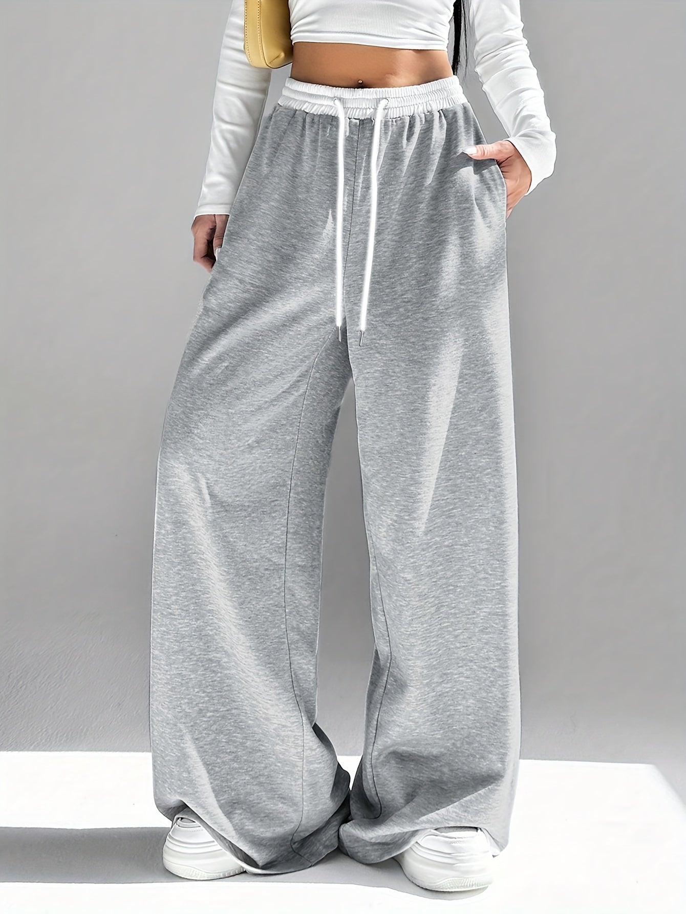 High waist wide leg drawstring pants in contrasting colors for women's spring and fall attire.