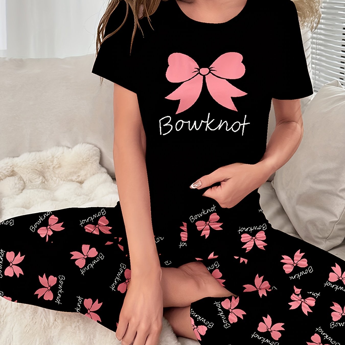 Women's sleepwear set with bow & slogan print, short sleeve top, and elastic pants.