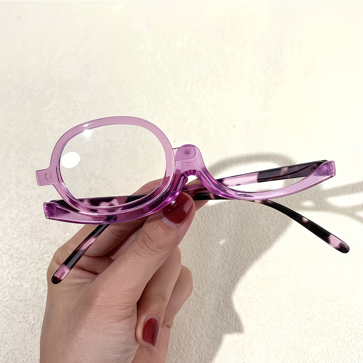 Rotating cosmetic reading glasses for makeup application, covering prescription range +1.0 to +4.0.