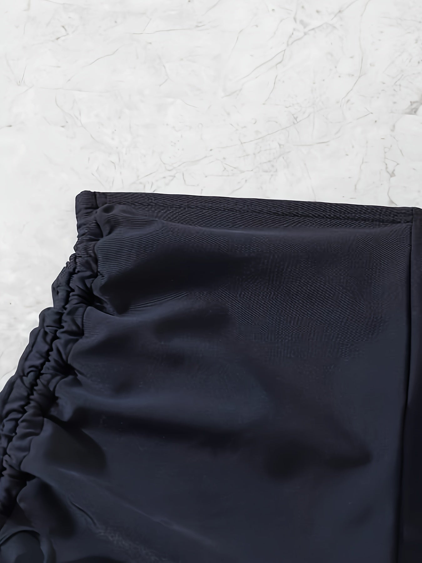 Black drawstring swim shorts for women.