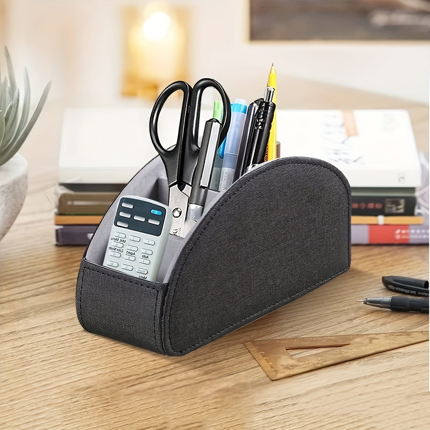 Compact faux leather remote control holder with 5 compartments for TV remotes, game controllers, and office supplies. Perfect for organizing on nightstands, desks, and tabletops. Ideal for home storage.