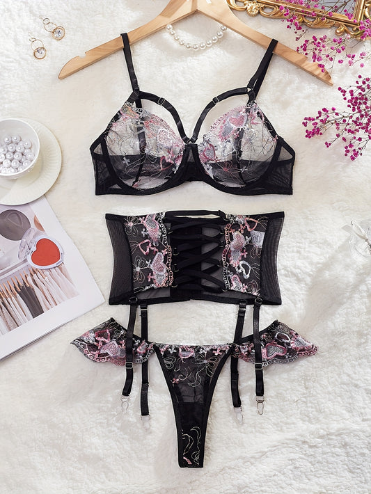 3-Piece lingerie set with heart embroidery, cross strappy detail, sheer mesh material in black with pink accents. Includes bra, garter belt, and thong.