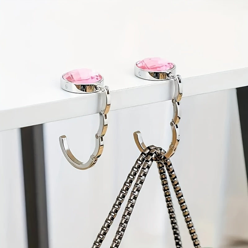 Hang your purse securely on desks in cafes, libraries, and more with the Portable Foldable Handbag Hook.