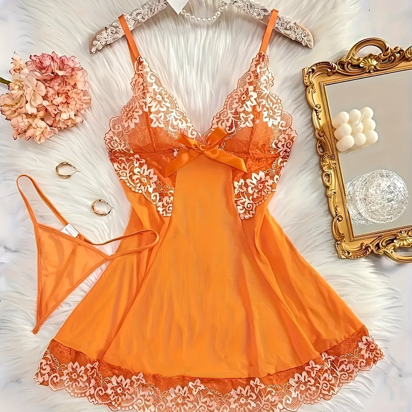 Sexy women's dress with deep V neckline, thin straps, bow decoration, and matching thong.