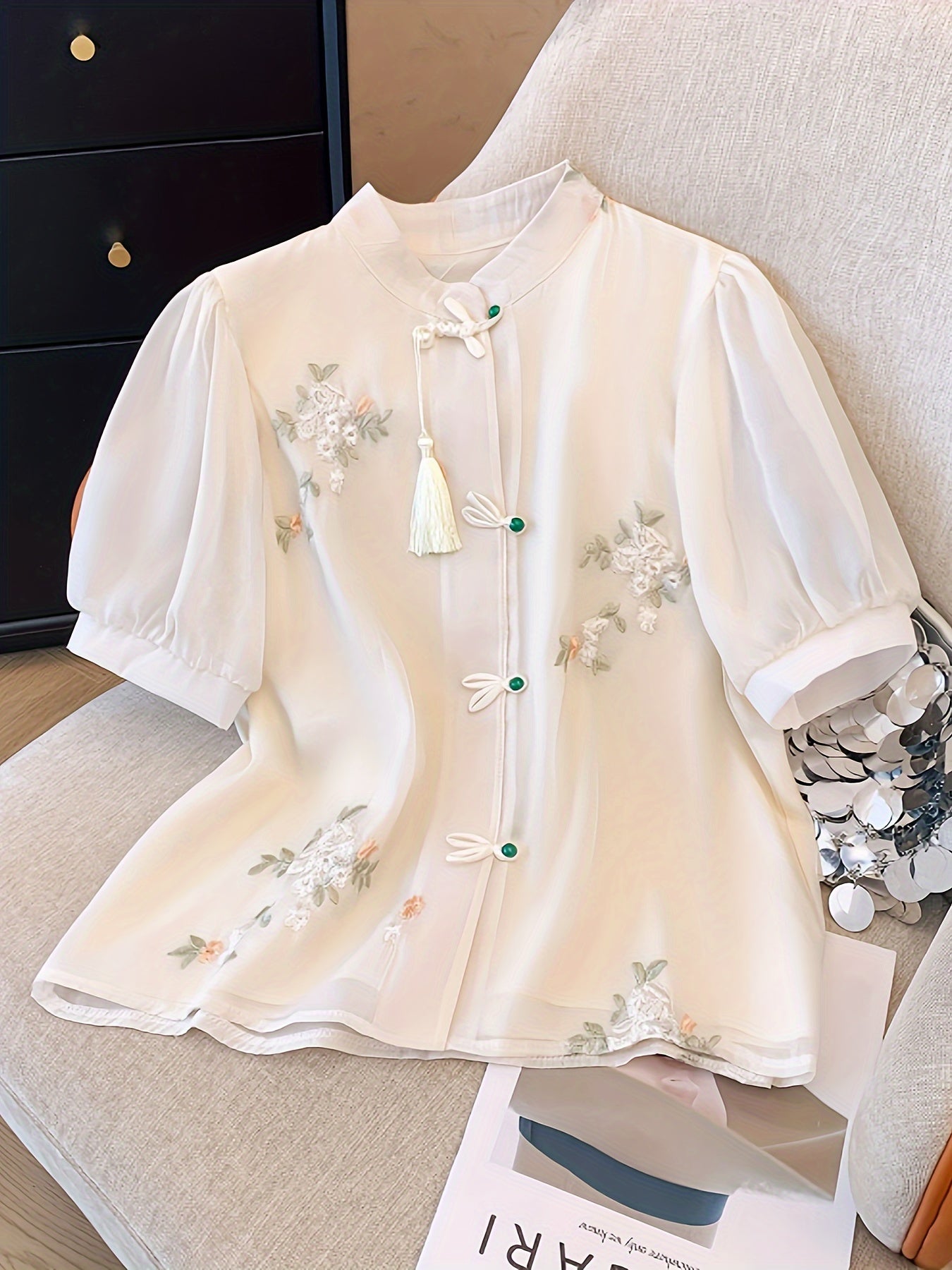 Women's chic floral blouse with green leaves & tassel details, ruffled cuffs, machine washable, perfect for spring/summer, casual chic style, button-up front, polyester fabric.