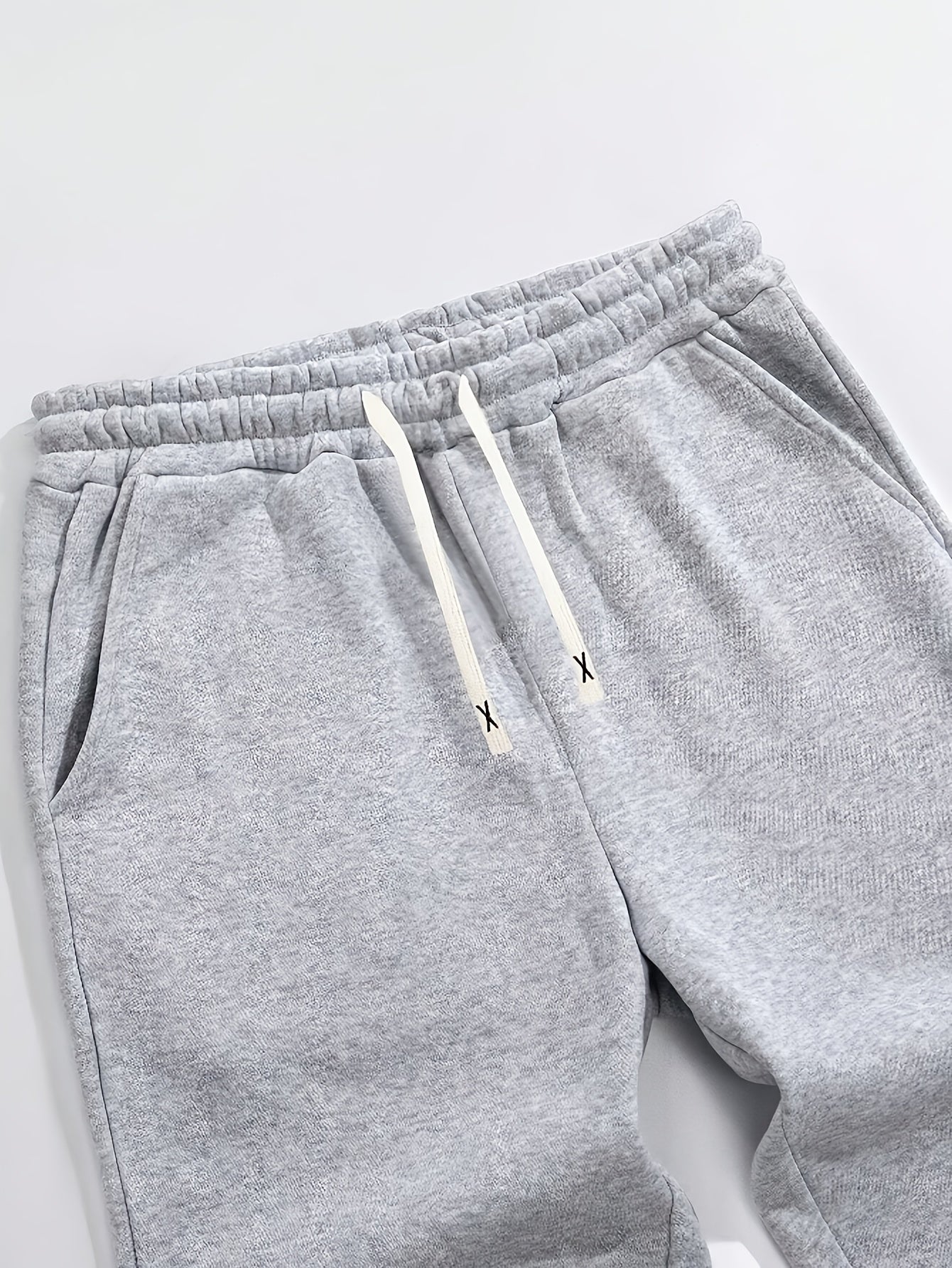 Casual men's sweatpants with letter print, made of polyester knit fabric with stretch. Regular fit with drawstring waist, comfortable for fall/winter.