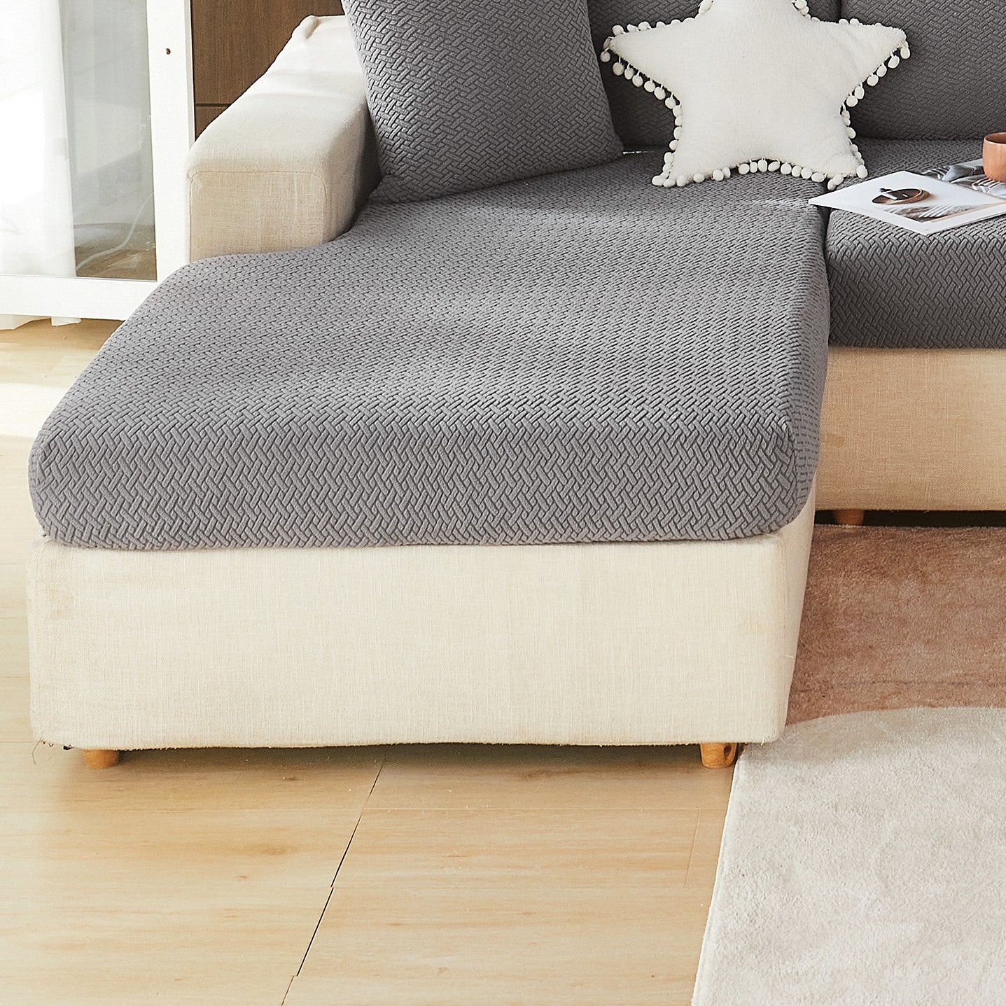 Modern gray sofa cushion cover with elastic fit and soft textured fabric. Machine washable for enhanced comfort in the living room.