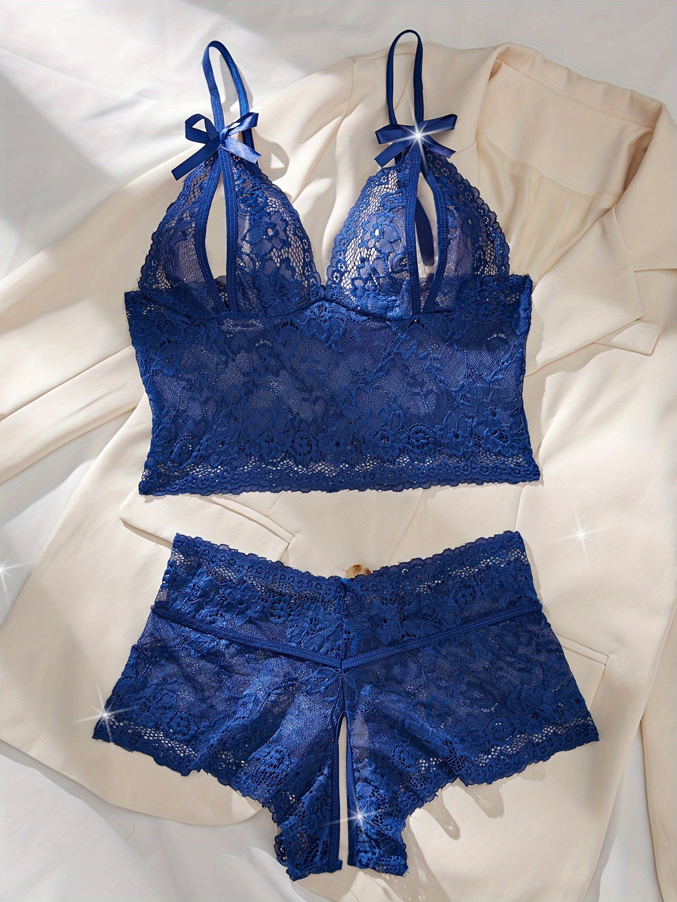 Floral lace lingerie set with bow bra and crotchless panties for a seductive look.