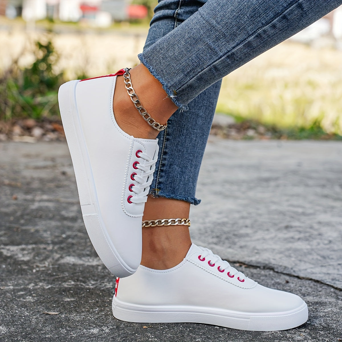 Versatile women's white sneakers with classic design, lace-up closure, round toe, and rubber sole for all seasons. Made with faux leather upper and comfortable fabric lining.