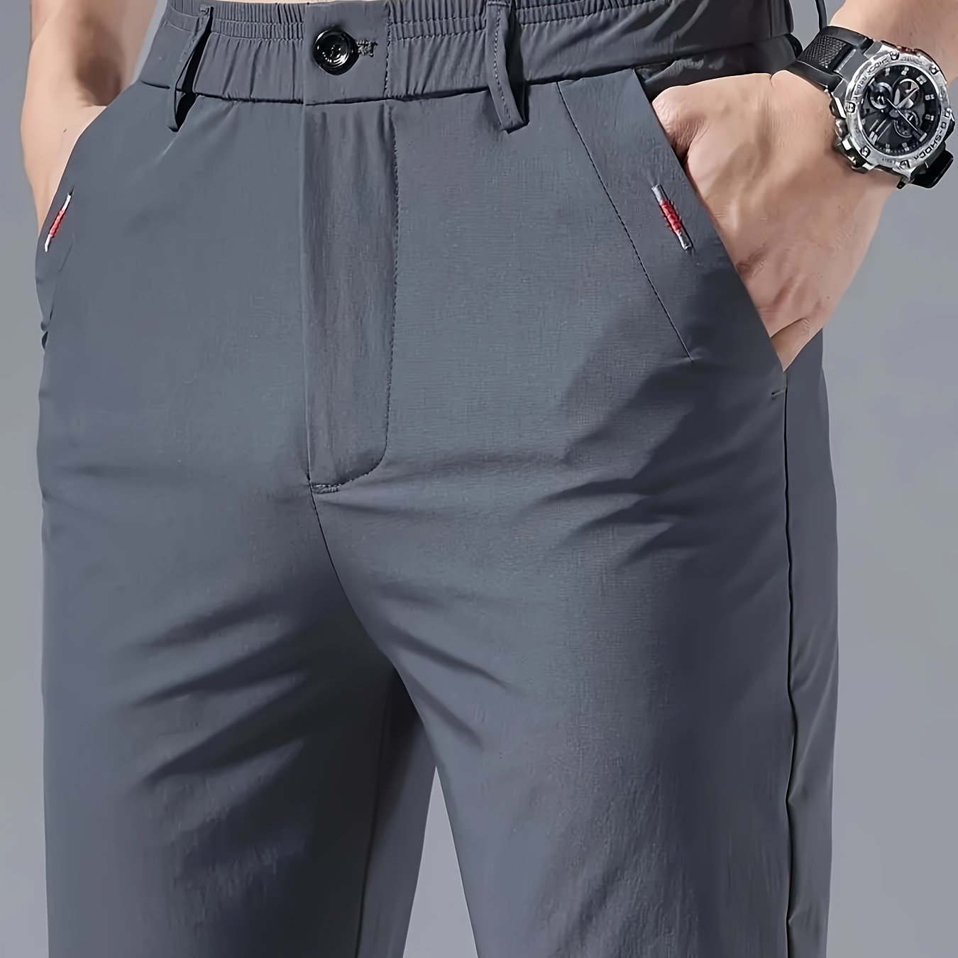 Men's slim fit casual pants made of breathable nylon fabric with pockets and embroidery. Suitable for outdoor and daily wear in a solid color basic style. Features zippered waist for