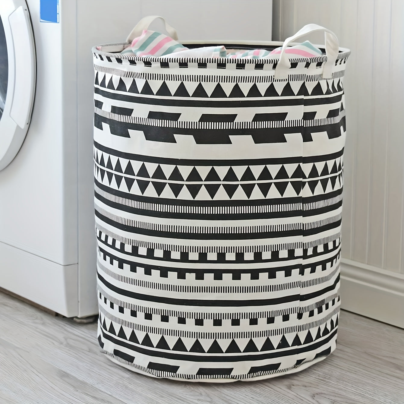 Large capacity fabric hamper for storing dirty clothes and linens, featuring a geometric design. This foldable storage basket can also be used for organizing clothes, dolls, and other items in your bathroom, bedroom, living room, or dorm. A stylish and