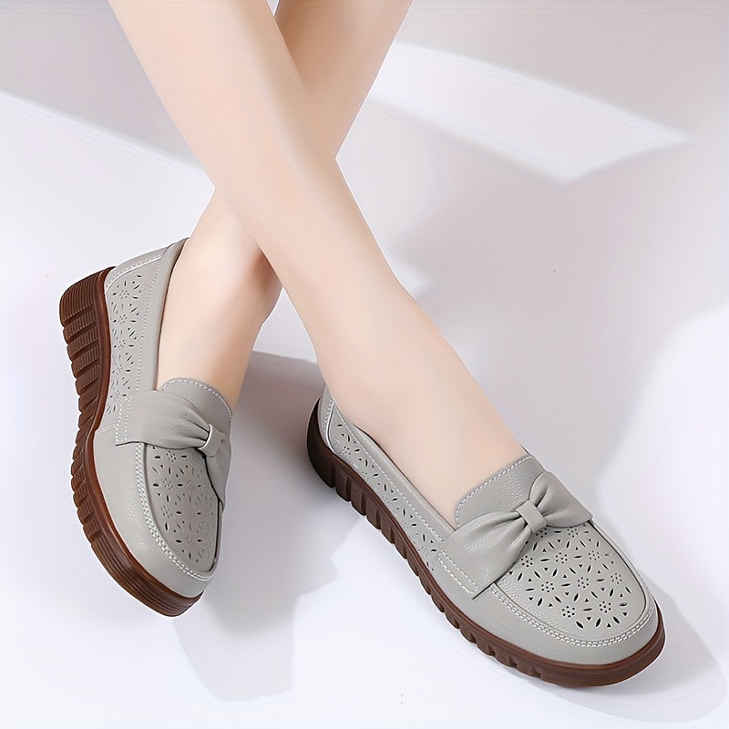 Flat loafers for women with hollow out design, bow detail, soft sole, suitable for casual walking.