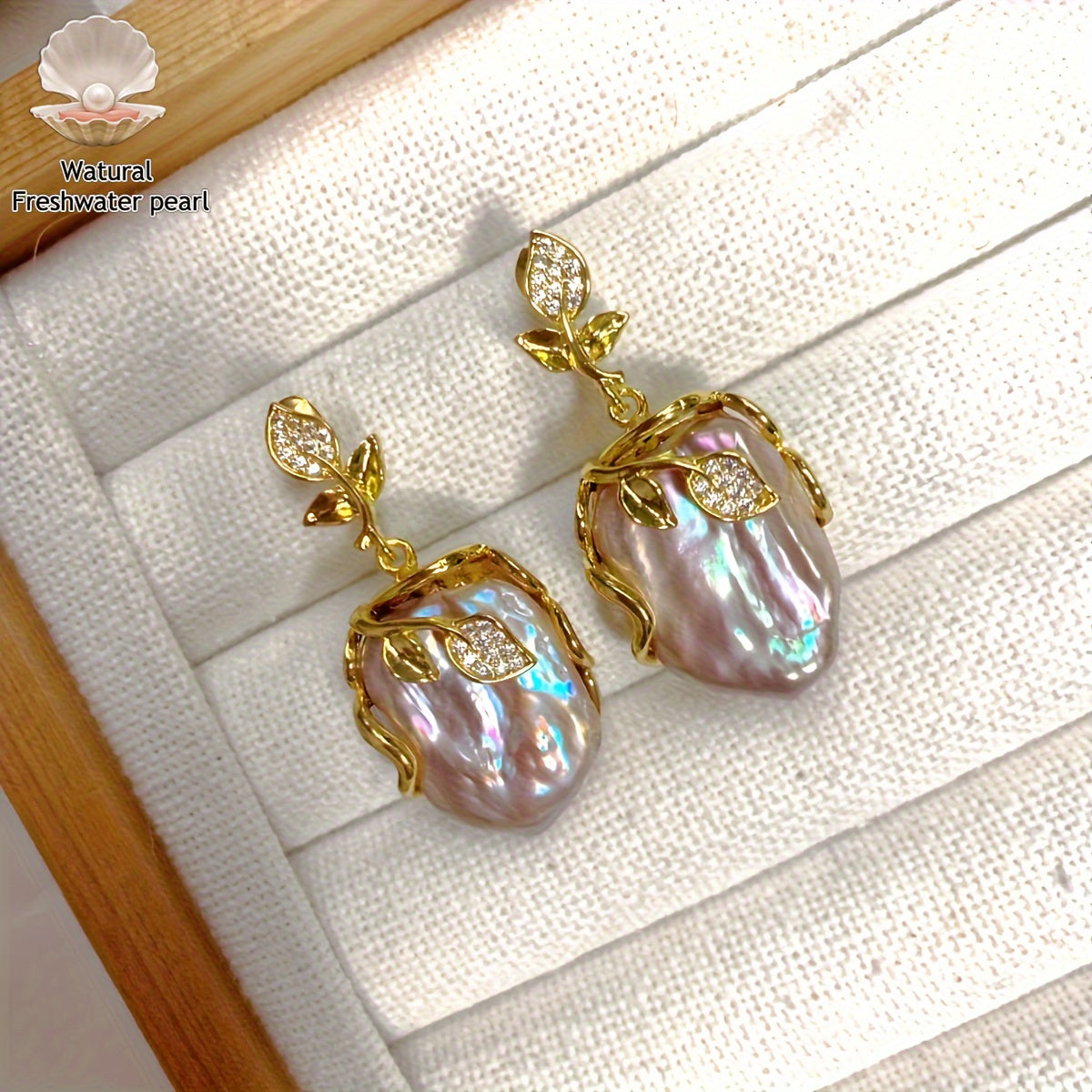 Elegant and luxurious French-inspired freshwater pearl earrings with gold-plated silver leaf accents, perfect for fashion-forward women with a taste for retro style and natural beauty.