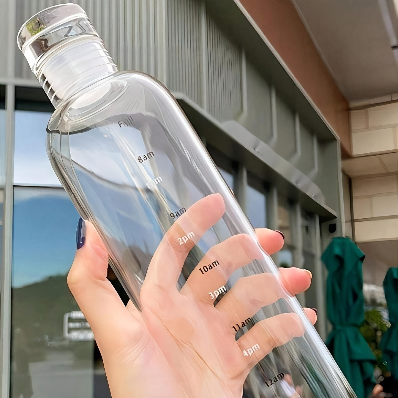 Reusable round plastic water bottle with time markers, ideal for various uses like office, school, and home, suitable for juice and iced drinks, hand wash only, and made of recyclable material.