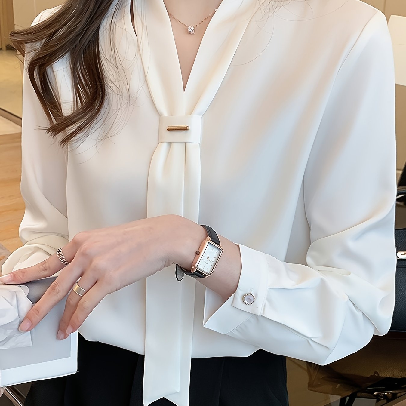 Slimming white chiffon blouse with tie-neck design, perfect for work or casual wear.