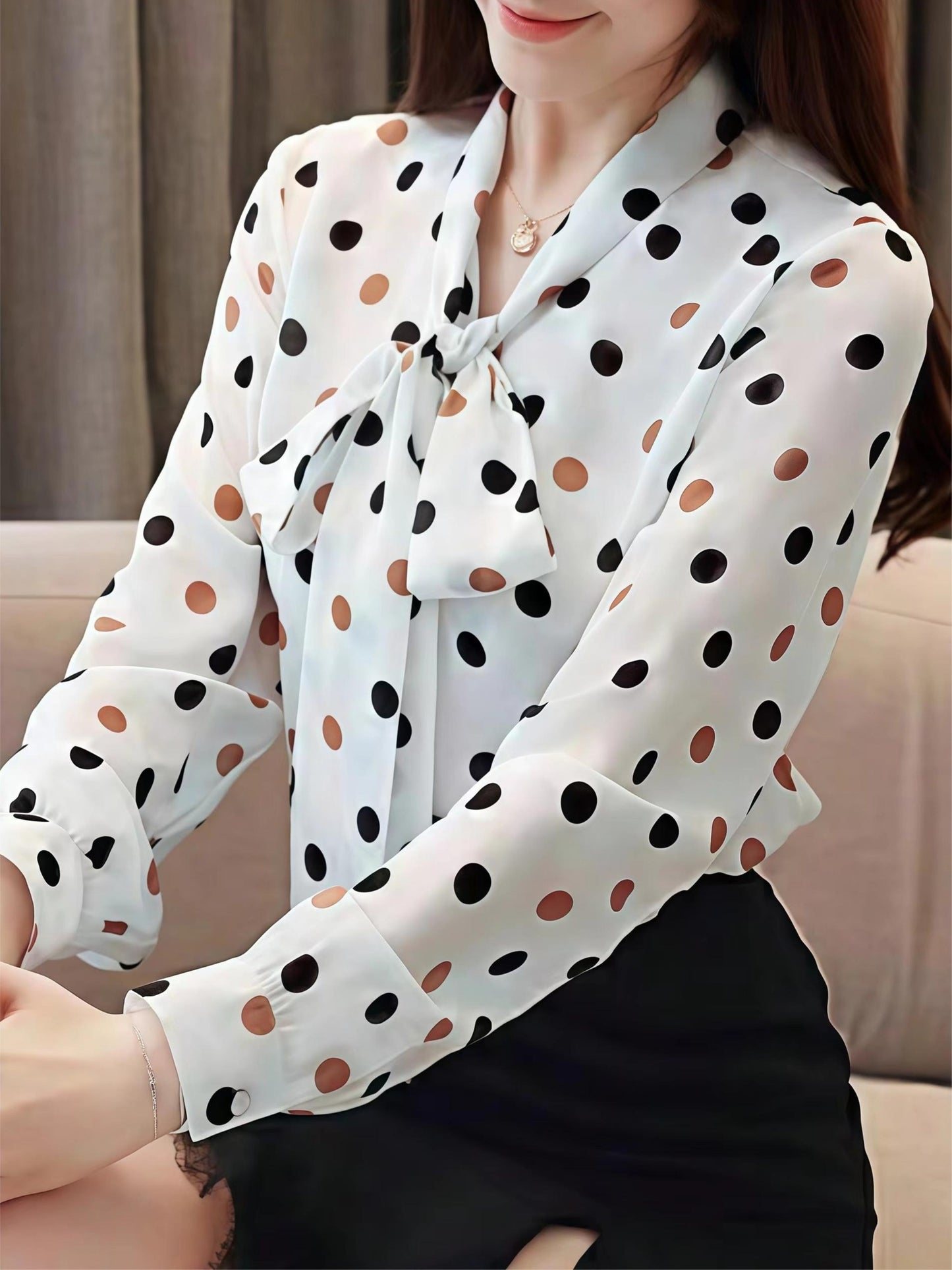 Elegant polka dot blouse with tie-neck detail, perfect for spring and fall.