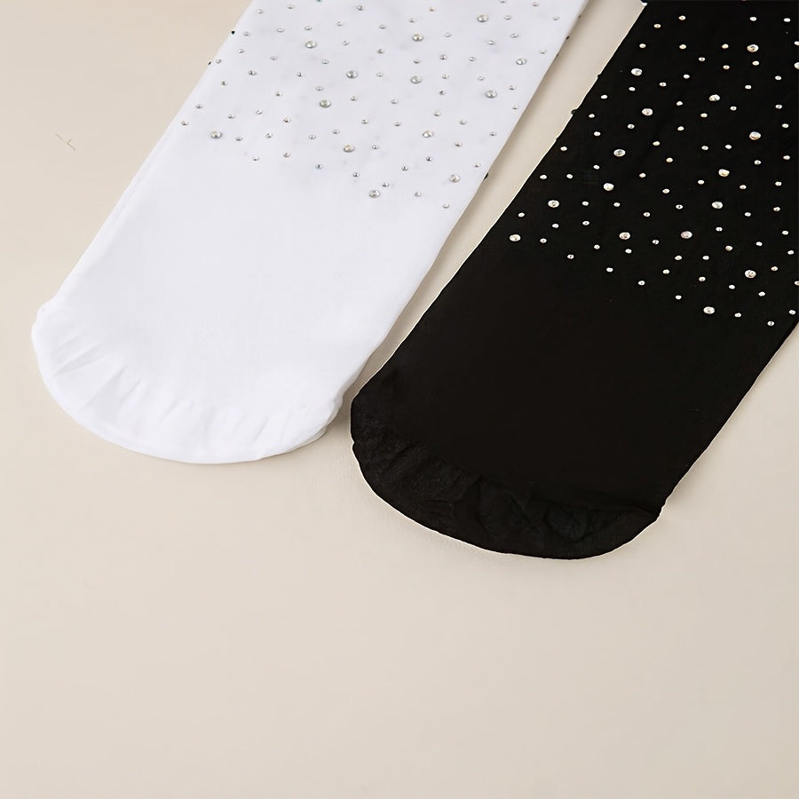 2 pairs of black and white rhinestone-studded tights for baby girls.