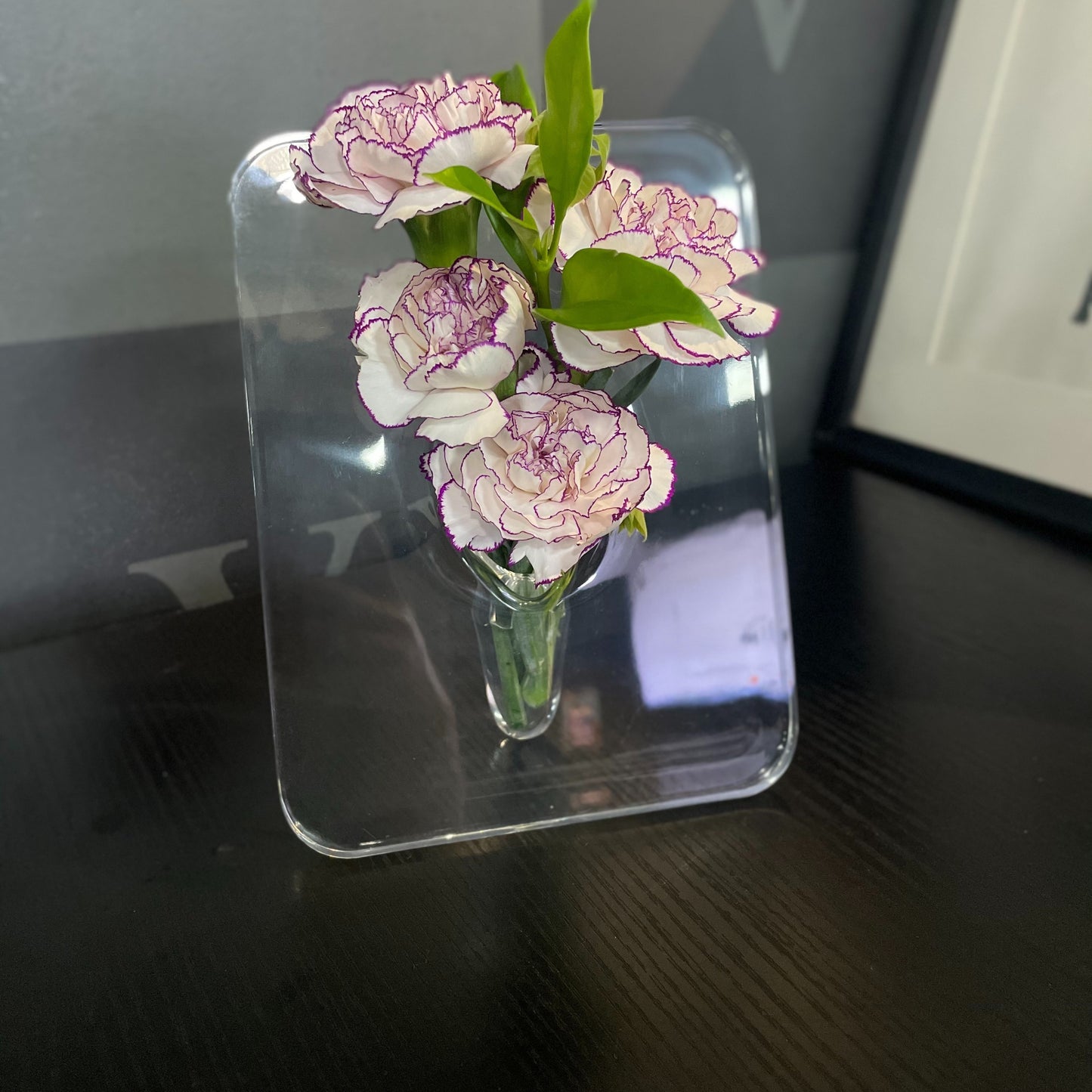 Art Deco-style acrylic resin bud vase with geometric transparent oblong design. Doubles as a creative picture frame. Ideal for home or office décor. Makes a great small gift (flowers not included).