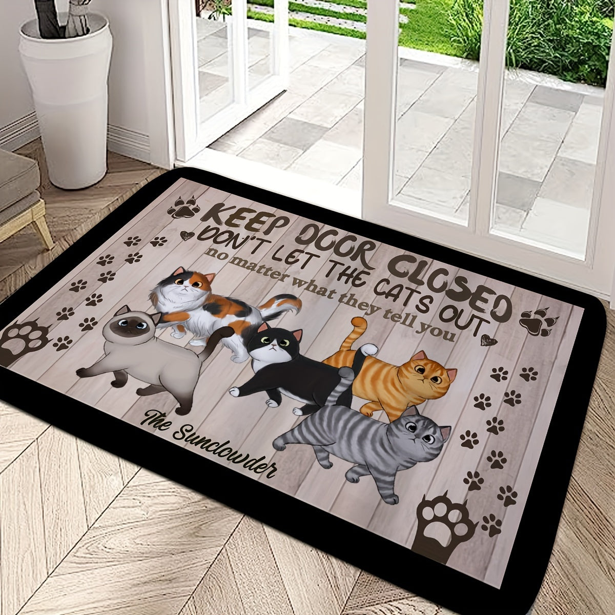 Welcome your guests with this whimsical cat-themed welcome mat featuring cute cartoon cats and paw prints. Made of non-slip, machine washable polyester, this door mat is perfect for both indoor and outdoor use. The black mat is complemented by a wooden