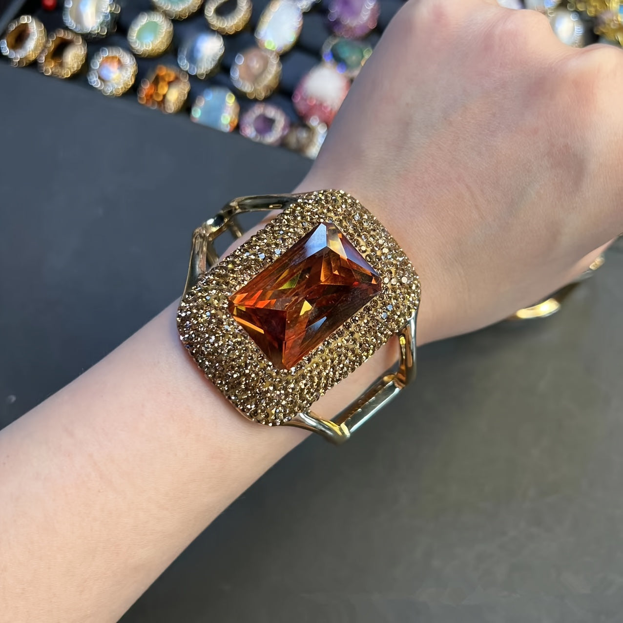 Add some sparkle to your outfit with this stunning Glitter Style Women's Cuff Bracelet! Featuring Rhinestone Accents and a Copper Base, its Large Open Design is sure to make a statement at parties and banquets. Get ready to shine with this Blingbling