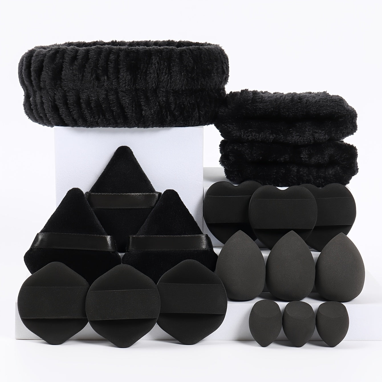 18-piece set including 1 hairband, 2 wristbands, 3 makeup sponges, 3 mini makeup sponges, 3 loose powder puffs, and 6 air cushion puffs. Features foundation mixing sponge for flawless