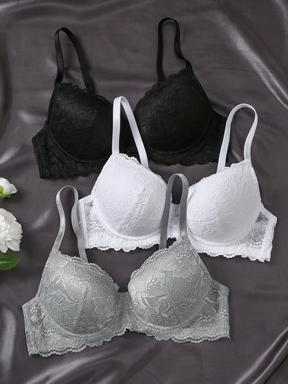 Three elegant lace push-up bras with underwire for women in black, white, and gray. Non-removable pads, hand washable, and comfortable polyamide blend.