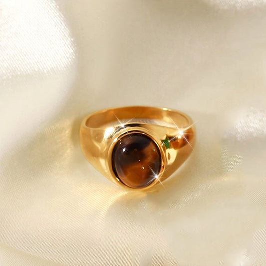 Elegant and vintage style golden wide ring featuring a shiny oval brown glass design. This fashion accessory is perfect for both formal banquets and everyday wear.