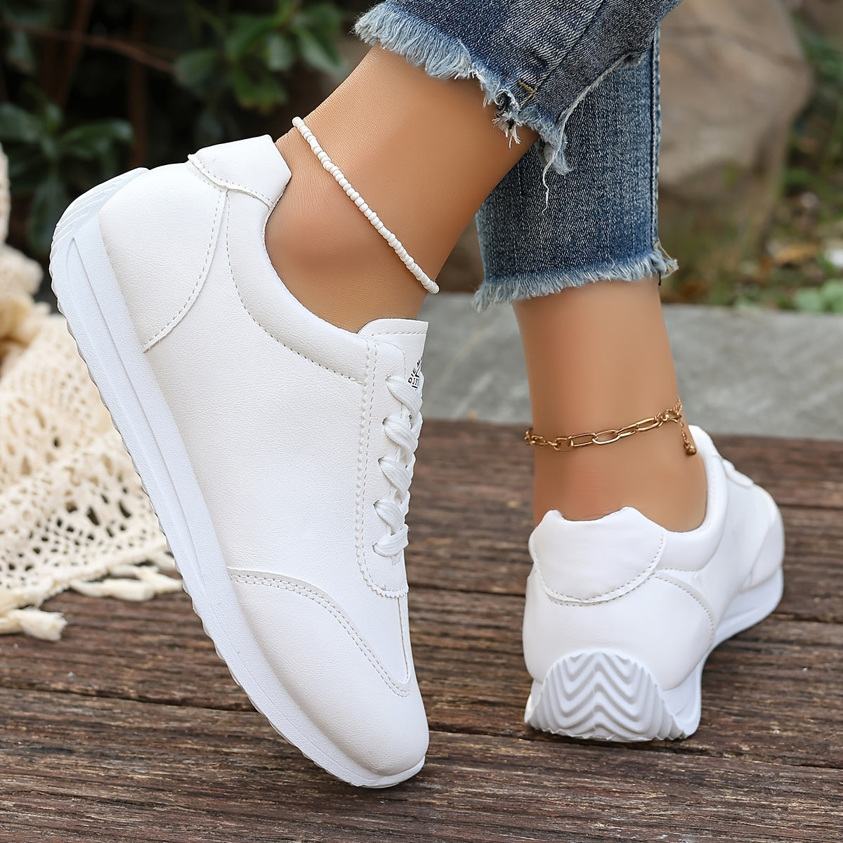 White synthetic leather women's casual sneakers with stability support, all-season comfort, and breathable fabric lining. Perfect for casual attire.