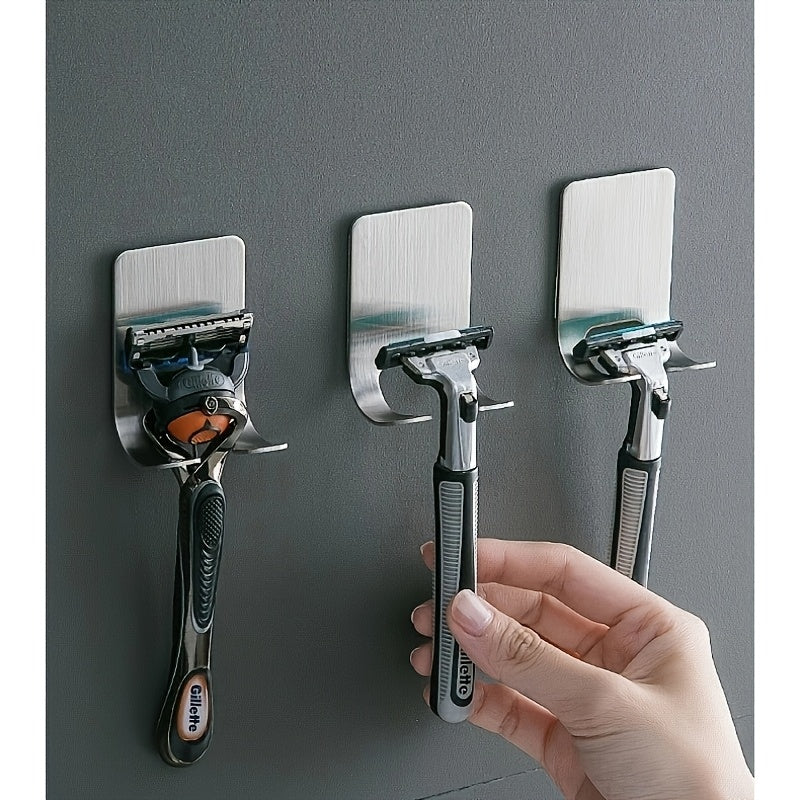 2 silver adhesive wall hooks for bathroom, bedroom, or kitchen. No drilling necessary. Made of stainless steel. Can hold shaver, hat, robe, or other items.