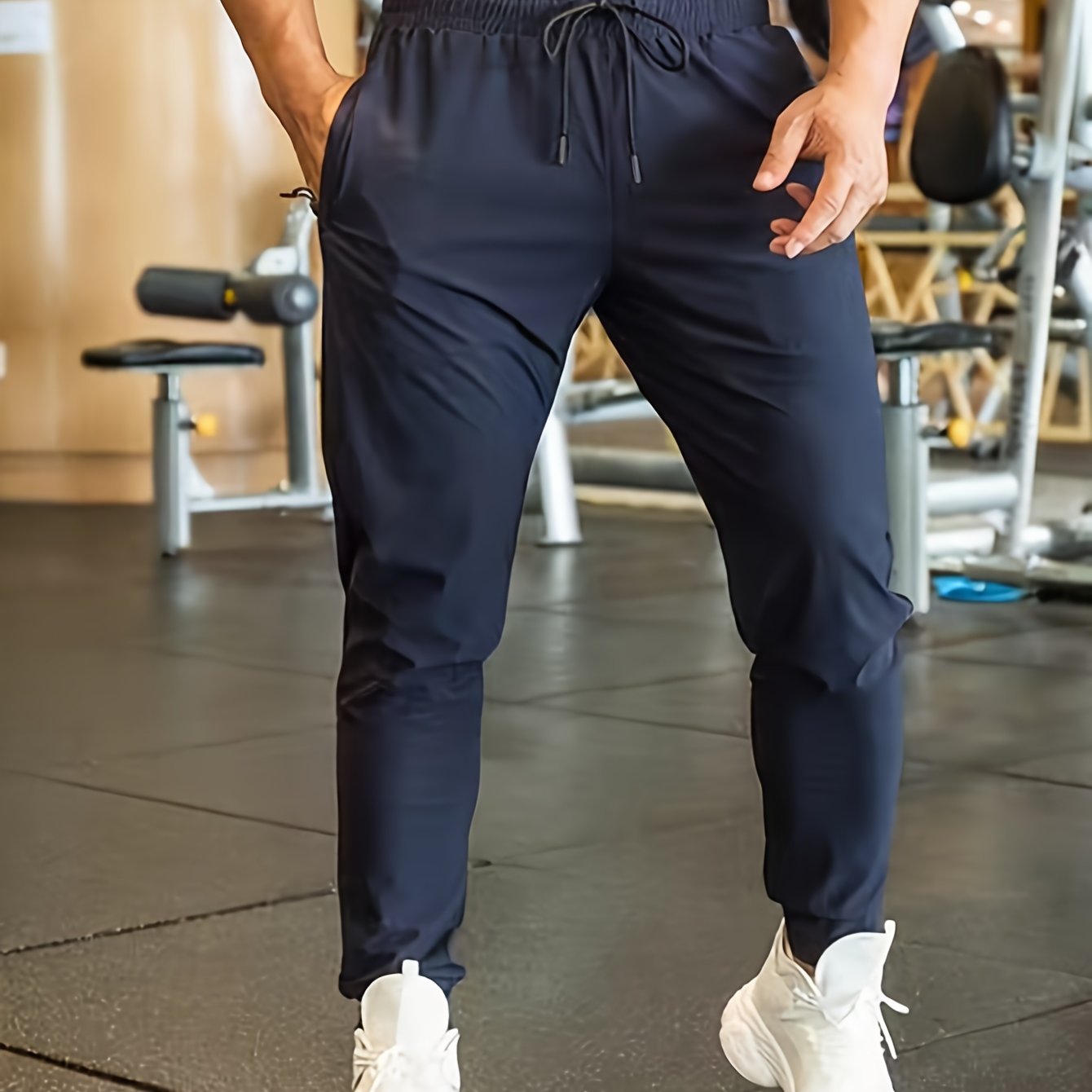 Men's athletic joggers in black made of breathable polyester with an elastic waistband and drawstring; suitable for gym, running, and casual wear.