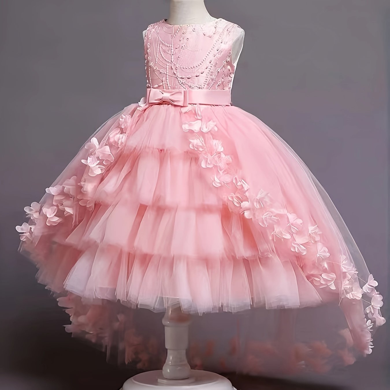 Elegant sleeveless dress with tiered mesh tutu, fake pearls, bowknot, and floral design for parties and balls.