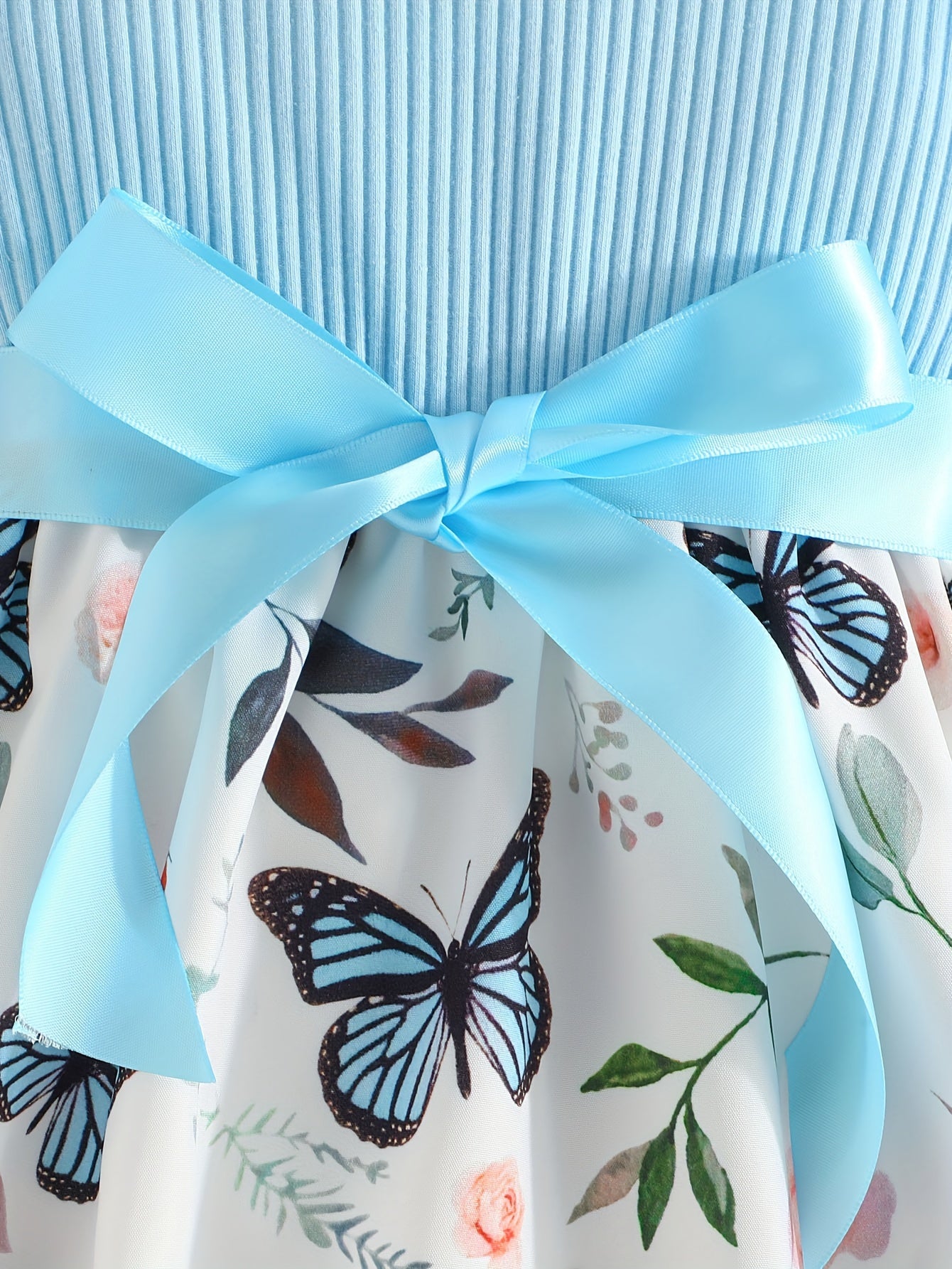 Girls' light blue ribbed cotton dress with butterfly & floral print, flutter sleeves & belt detail. Casual summer wear, machine washable. Dresses for girls.