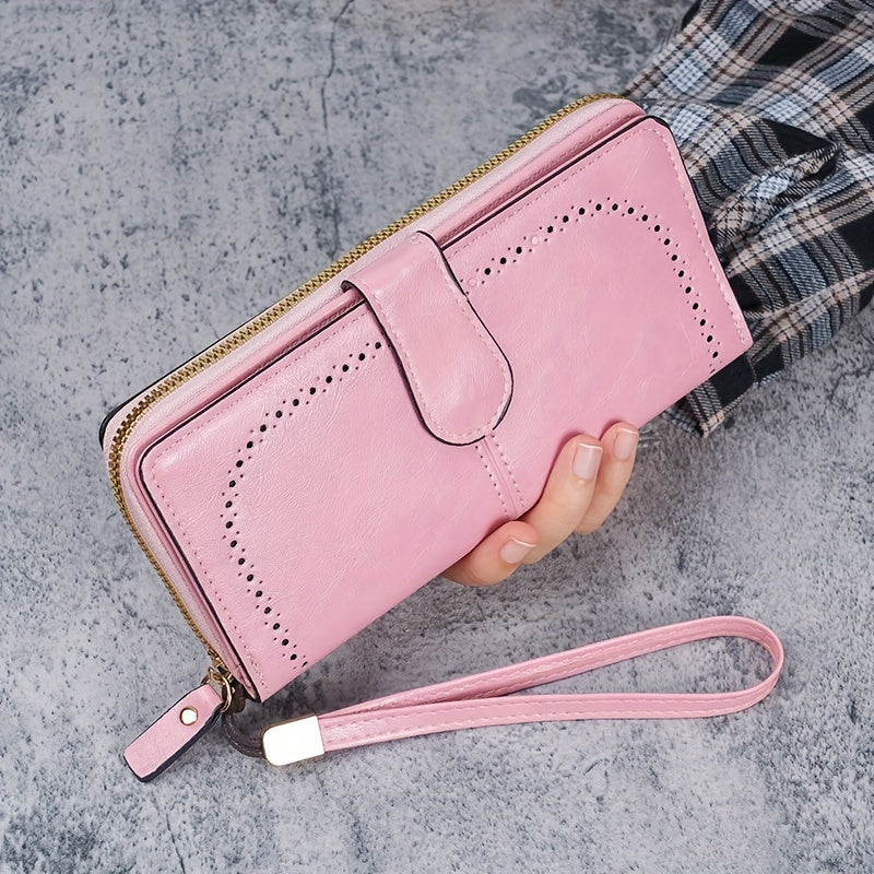 Black faux leather long clutch wallet with wristlet, ID card compartment, button closure, and edge paint. Dry clean only.