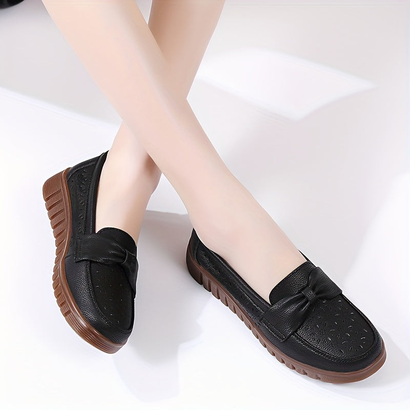 Flat loafers for women with hollow out design, bow detail, soft sole, suitable for casual walking.