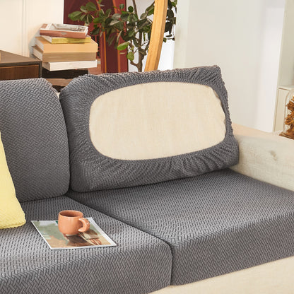 Modern gray sofa cushion cover with elastic fit and soft textured fabric. Machine washable for enhanced comfort in the living room.