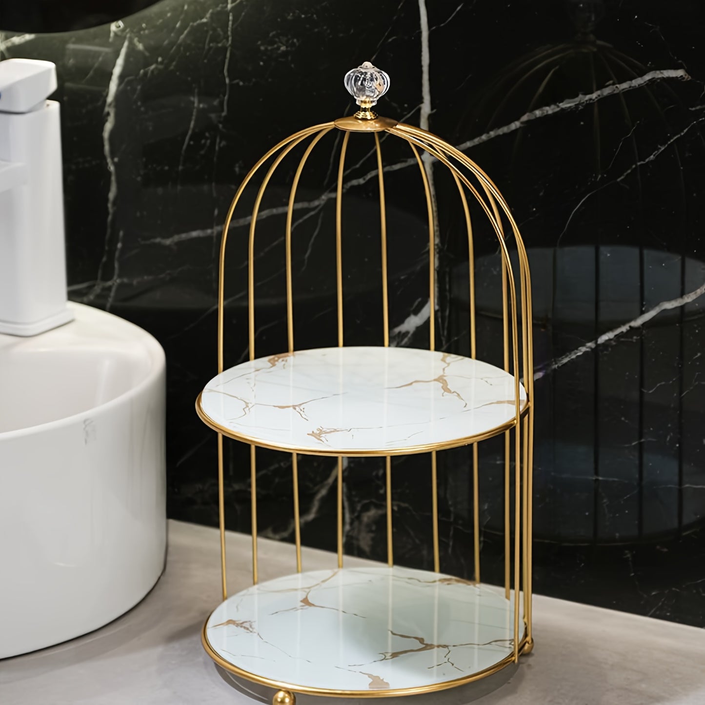 Elegant golden and white marble birdcage-inspired 2-tier makeup organizer with stainless steel rack and electrostatic spray finish. Portable and freestanding for bathroom and bedroom decor.