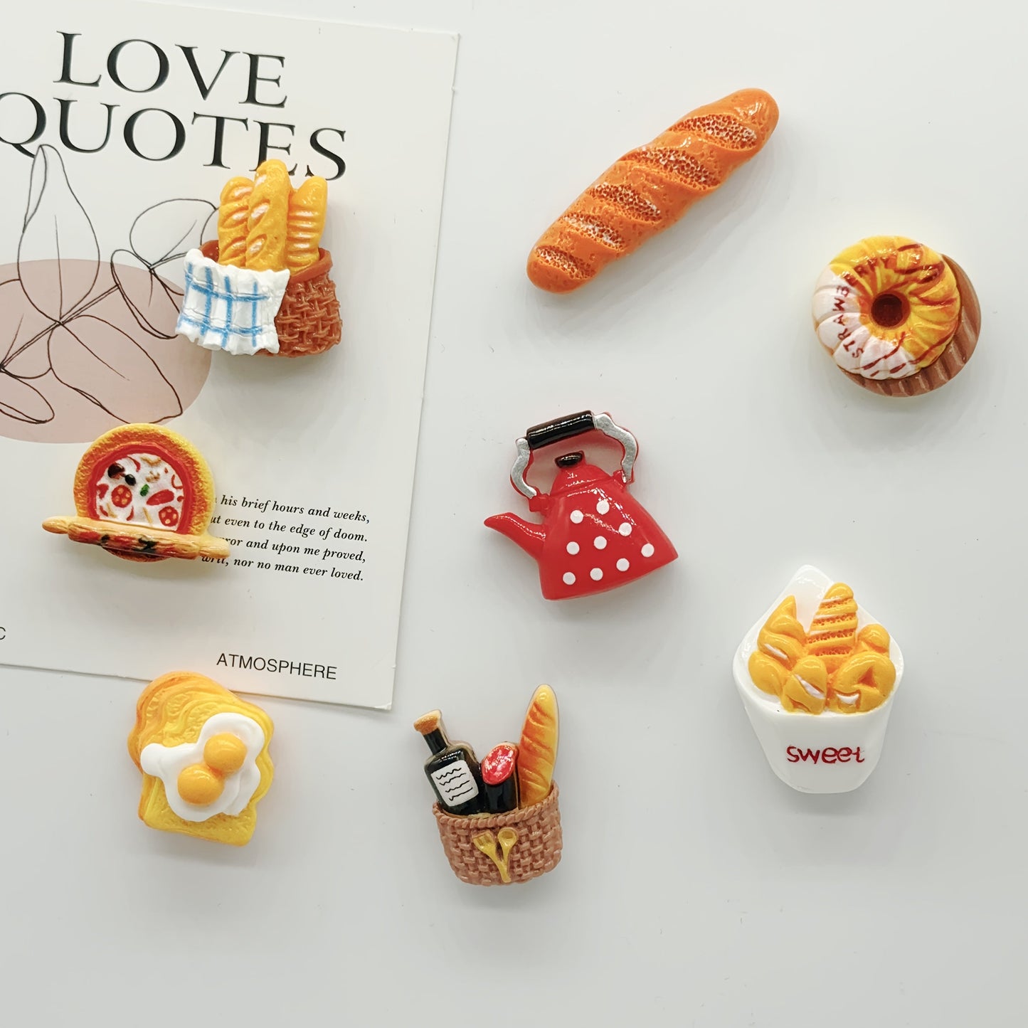 Set of 8 plastic fridge magnets featuring oval baguettes, toast, and tart designs. These magnets have a strong hold for securely attaching to metal surfaces. Add a cute touch to your kitchen decor or use them on a photo message board. Perfect for adding