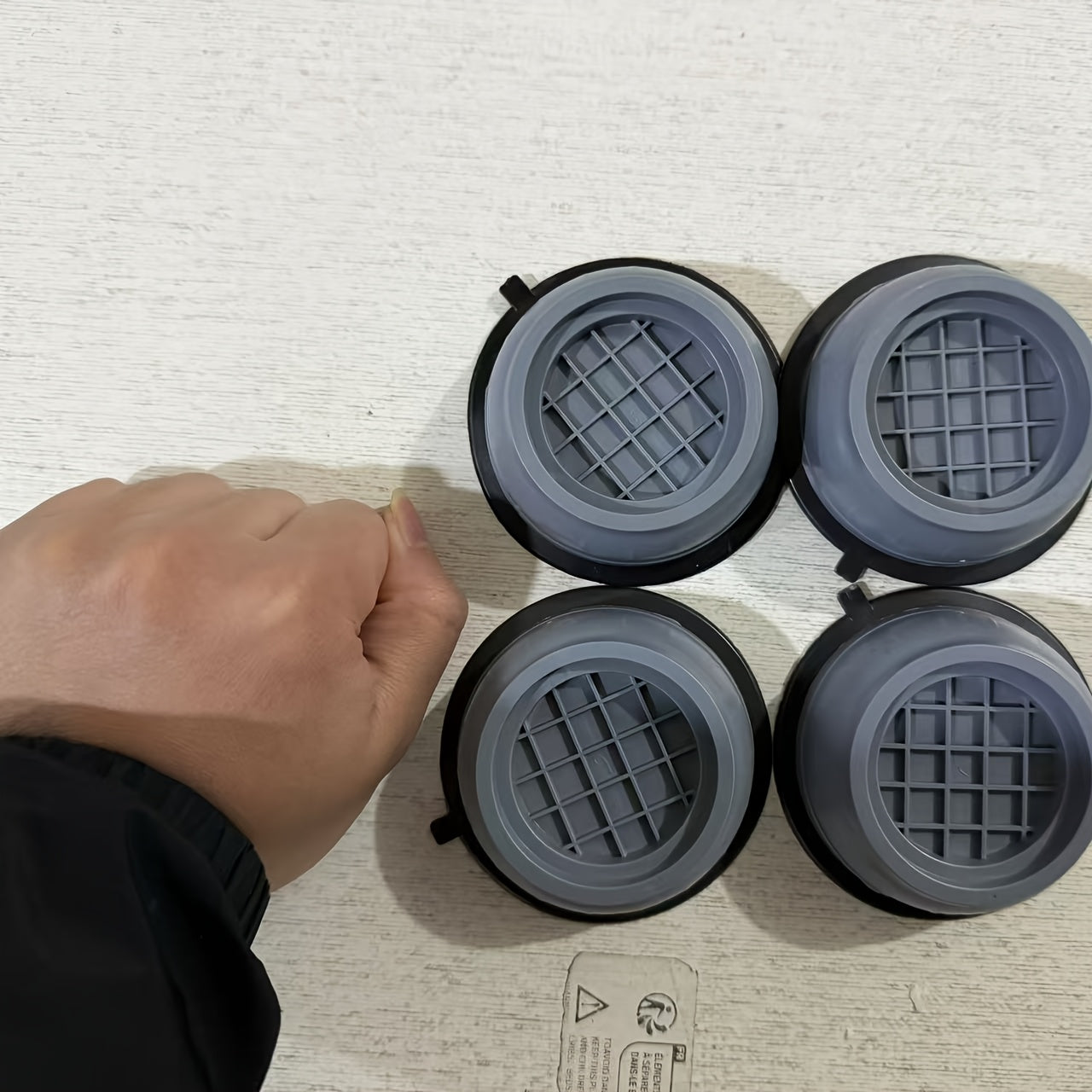 Four large anti-vibration pads made of durable plastic material dampen shock and cancel noise for washing machine stability, reducing vibration and noise.