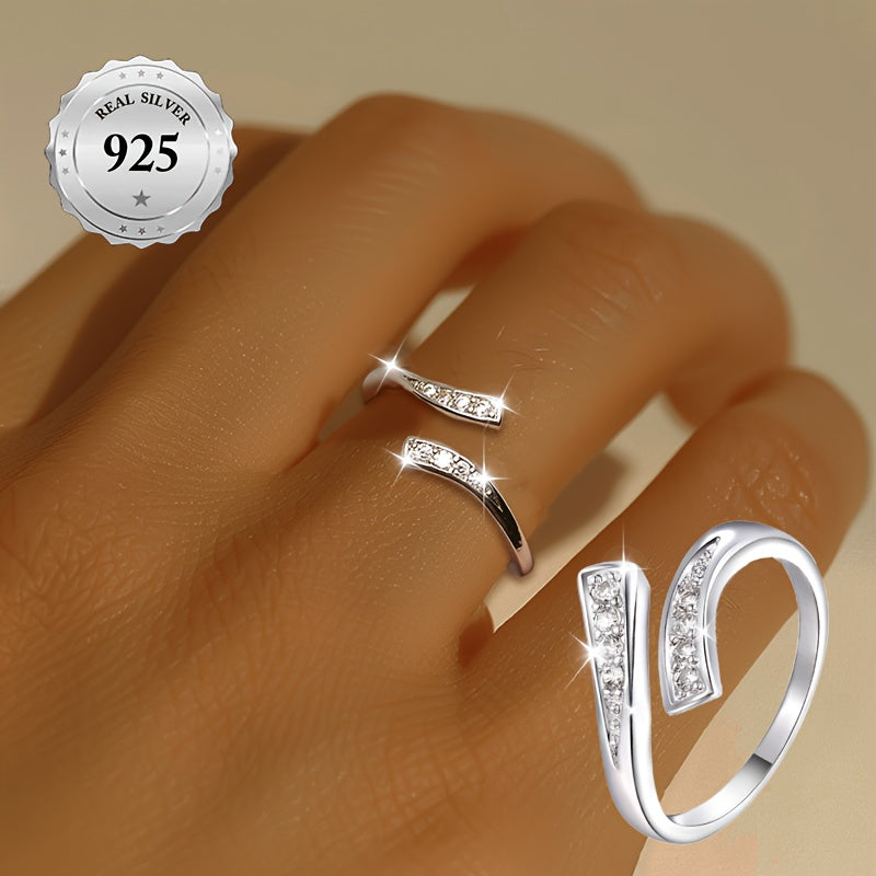 A stylish women's open ring featuring an infinity symbol and an endless loop design adorned with sparkling synthetic cubic zirconia for added bling. This minimalist and classic piece is made from lightweight 1.5g 925 sterling silver, making it suitable