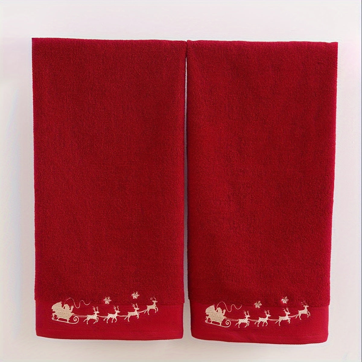 2 QIBHI Vintage Christmas Reindeer embroidered hand towels made from 100% cotton knit fabric. Cartoon-themed oblong bathroom towels perfect for festive holiday gifts. Hand wash only, 450gsm. Adds a playful holiday motif and soft festive texture to your