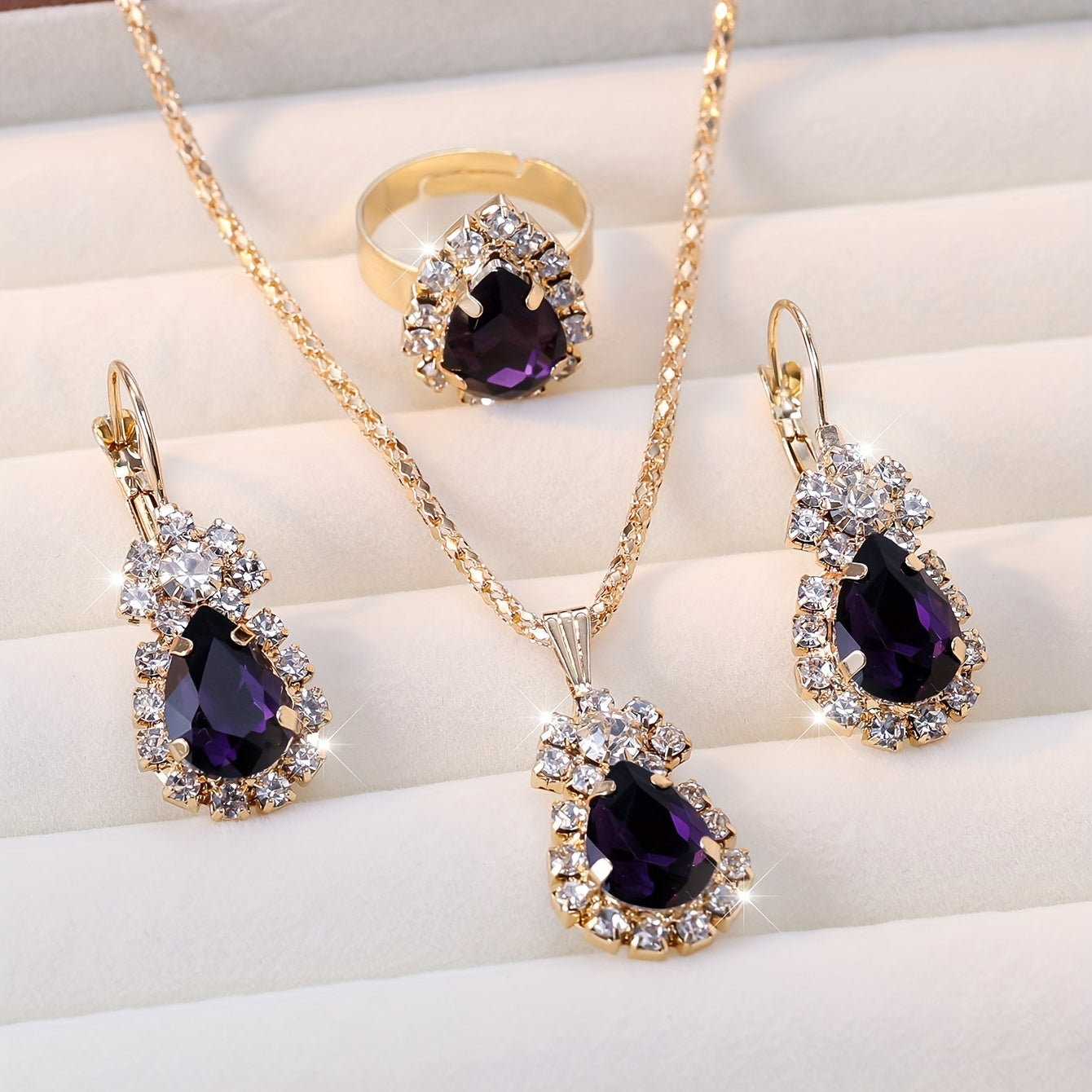 Complete your look with this elegant jewelry set featuring 4 pieces - earrings, necklace, and ring. Made with 18k gold plating and inlaid with shimmering zirconia in multiple colors to suit your style. Perfect for daily wear or adding a touch of glamour