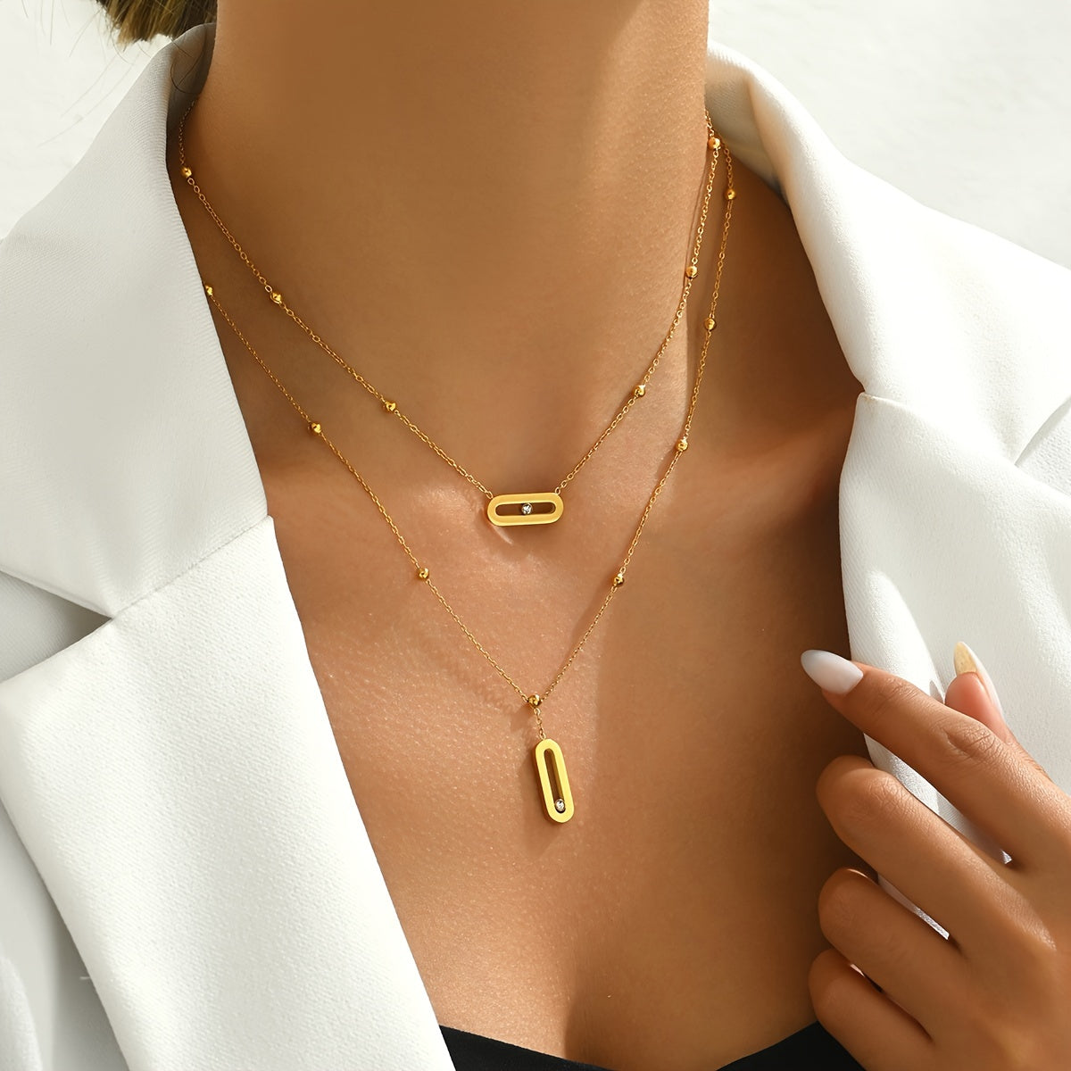 Elevate your look with this sophisticated French-inspired 18K gold plated stainless steel necklace featuring double layers and sparkling rhinestone accents. The versatile geometric pendant is perfect for women, ideal for both everyday wear and as a