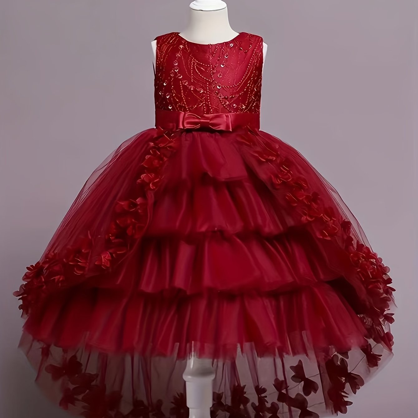 Stylish pink princess dress for girls with floral appliqués, tulle overlay, and bow detail - perfect for pageants, parties, and performances.