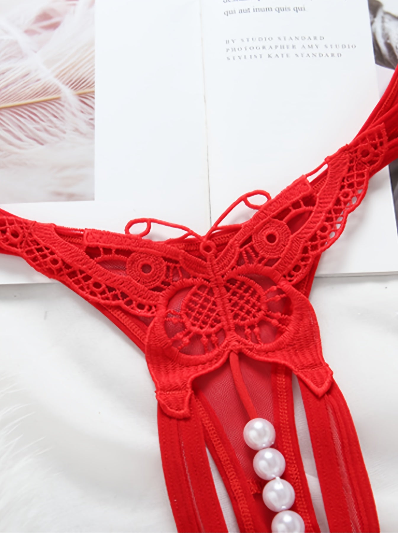 One sexy embroidered sheer thong with pearls, crotchless panties featuring animal pattern beading and a breathable polyester knit fabric.